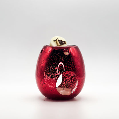 Red mercury glass wax melt burner with a festive christmas pomander wax melt and natural tea light.