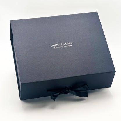 Black gift box with a black satin bow on a white background, featuring the brand 'Lavender and Lemon'.