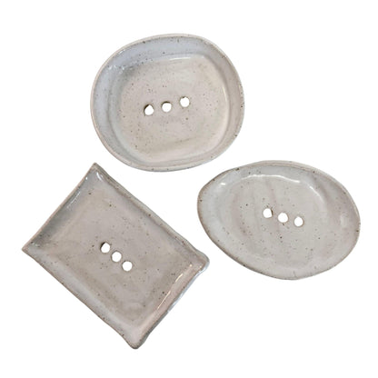 Three small ceramic soap dishes in different shapes with three-button tops, shown on a plain white background.